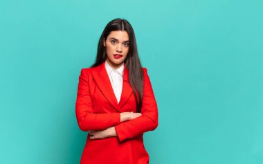 young pretty woman doubting or thinking, biting lip and feeling insecure and nervous, looking to copy space on the side. business concept