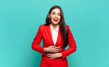 young pretty woman laughing out loud at some hilarious joke, feeling happy and cheerful, having fun. business concept