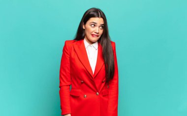 young pretty woman looking worried, stressed, anxious and scared, panicking and clenching teeth. business concept