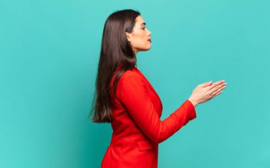 young pretty woman smiling, greeting you and offering a hand shake to close a successful deal, cooperation concept. business concept