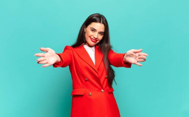 young pretty woman smiling cheerfully giving a warm, friendly, loving welcome hug, feeling happy and adorable. business concept