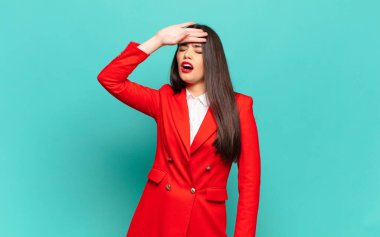 young pretty woman looking stressed, tired and frustrated, drying sweat off forehead, feeling hopeless and exhausted. business concept