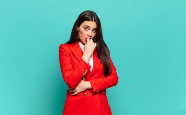 young pretty woman feeling serious, thoughtful and concerned, staring sideways with hand pressed against chin. business concept