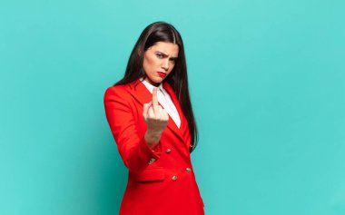 young pretty woman feeling angry, annoyed, rebellious and aggressive, flipping the middle finger, fighting back. business concept