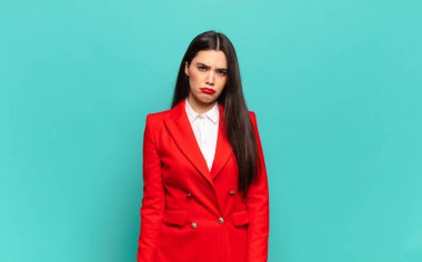 young pretty woman feeling sad, upset or angry and looking to the side with a negative attitude, frowning in disagreement. business concept