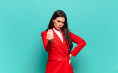 young pretty woman making capice or money gesture, telling you to pay your debts!. business concept