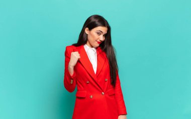 young pretty woman looking arrogant, successful, positive and proud, pointing to self. business concept