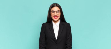 young pretty woman looking happy and goofy with a broad, fun, loony smile and eyes wide open. business concept