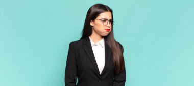 young pretty woman with a goofy, crazy, surprised expression, puffing cheeks, feeling stuffed, fat and full of food. business concept