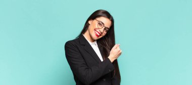 young pretty woman feeling happy, positive and successful, motivated when facing a challenge or celebrating good results. business concept