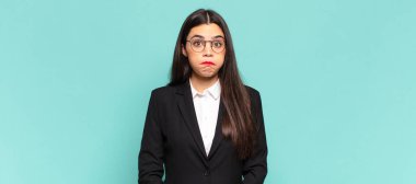 young pretty woman looking goofy and funny with a silly cross-eyed expression, joking and fooling around. business concept