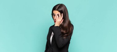 young pretty woman feeling bored, frustrated and sleepy after a tiresome, dull and tedious task, holding face with hand. business concept