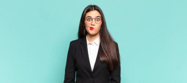 young pretty woman feeling confused and doubtful, wondering or trying to choose or make a decision. business concept