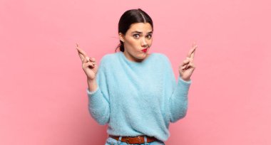 Genç ve güzel bir kadın endişeyle şans diliyor ve endişeli bir bakışla iyi şanslar diliyor.