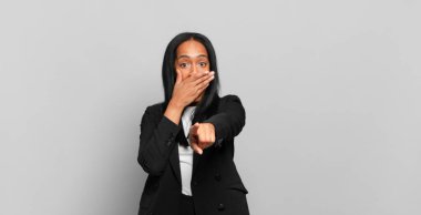 young black woman laughing at you, pointing to camera and making fun of or mocking you. business concept