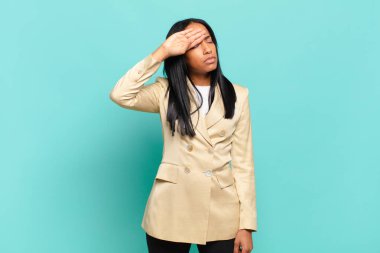 young black woman looking stressed, tired and frustrated, drying sweat off forehead, feeling hopeless and exhausted. business concept