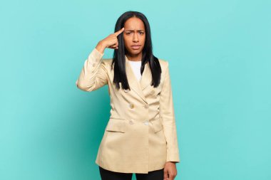 young black woman feeling confused and puzzled, showing you are insane, crazy or out of your mind. business concept