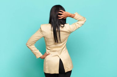 young black woman thinking or doubting, scratching head, feeling puzzled and confused, back or rear view. business concept
