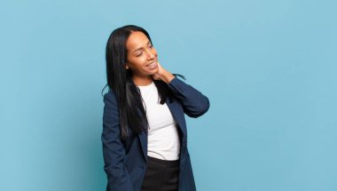 young black woman smiling cheerfully and casually, taking hand to head with a positive, happy and confident look. business concept