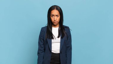young black woman feeling clueless, confused and uncertain about which option to pick, trying to solve the problem. business concept