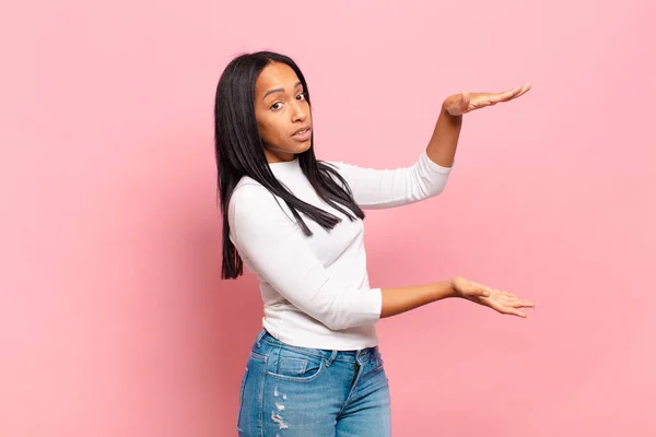 Young Black Woman Holding Object Both Hands Side Copy Space —  Fotos de Stock