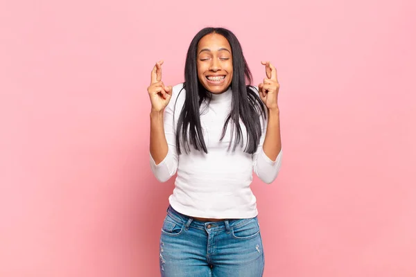 Young Black Woman Smiling Anxiously Crossing Both Fingers Feeling Worried —  Fotos de Stock
