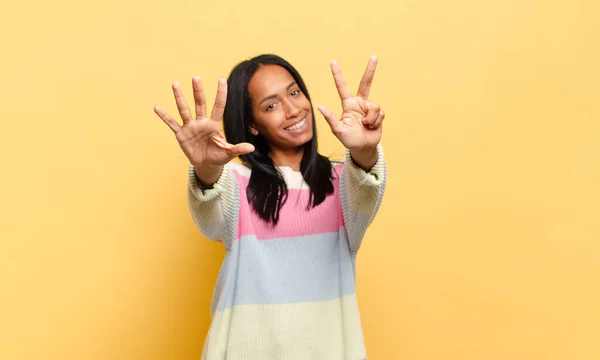 Young Black Woman Smiling Looking Friendly Showing Number Eight Eighth — Stockfoto