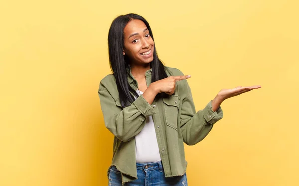 Young Black Woman Smiling Cheerfully Pointing Copy Space Palm Side — Stock Photo, Image