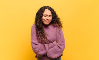 Genç İspanyol kadın endişeli, hasta, hasta ve mutsuz hissediyor. Ağrılı bir mide ağrısı ya da grip geçiriyor.