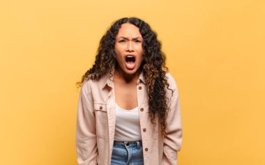 Genç İspanyol kadın şok olmuş, kızgın, sinirli ya da hayal kırıklığına uğramış, ağzı açık ve öfkeli görünüyor.