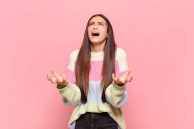 Genç ve güzel bir kadın umutsuz ve hayal kırıklığına uğramış görünüyor, stresli, mutsuz ve sinirli, bağırıyor ve çığlık atıyor.