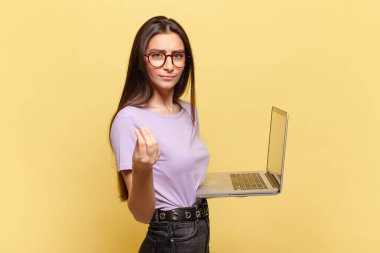 Genç ve güzel bir kadın sana borcunu ödemeni söyleyerek kapiş ya da para hareketi yapıyor. dizüstü bilgisayar