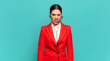 young pretty woman feeling puzzled and confused, with a dumb, stunned expression looking at something unexpected. telemarketer concept