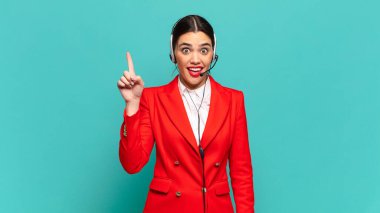 Genç ve güzel bir kadın bir fikri fark ettikten sonra mutlu ve heyecanlı bir dahi gibi hissediyor, neşeli bir şekilde parmağını kaldırıyor, eureka! tele pazarlamacı kavramı