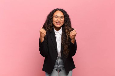 Genç İspanyol kadın şok olmuş, heyecanlı ve mutlu hissediyor, gülüyor ve başarıyı kutluyor, vay canına! iş kavramı