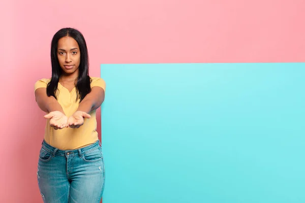 Young Black Woman Smiling Happily Friendly Confident Positive Look Offering — Zdjęcie stockowe