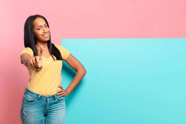 Young Black Woman Smiling Proudly Confidently Making Number One Pose — Zdjęcie stockowe