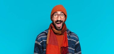 Genç, deli, sakallı adam. Şok olmuş ya da şaşırmış bir ifade ve kışlık kıyafetler.