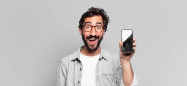 Genç, deli, sakallı adam. Şaşırmış ya da şok olmuş. telefon ekranı kavramı