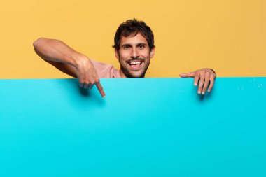 Genç, yakışıklı Hintli adam. İşaret işareti. Mutlu ve şaşırmış