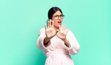 Dehşete kapılmış, korku ve panik içinde çığlık atan, kabusa tepki veren genç ve güzel bir kadın. pijama konsepti