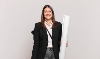 Genç, güzel bir mimar. Mutlu ve hoş bir şekilde şaşırmış görünüyor. Büyülenmiş ve şok olmuş bir ifadeyle heyecanlanıyor.