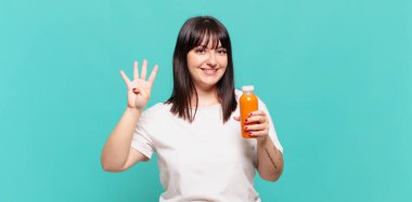 Gülümsüyor ve dost canlısı görünüyor, 4 ya da 4 numarayı gösteriyor, elle ileri doğru, geri sayıyor.