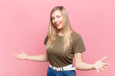 Genç sarışın güzel kadın mutlu, kibirli, gururlu ve kendini beğenmiş görünüyor.