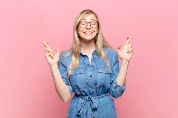 Young Blond Pretty Woman Smiling Anxiously Crossing Both Fingers Feeling — Stock Photo, Image