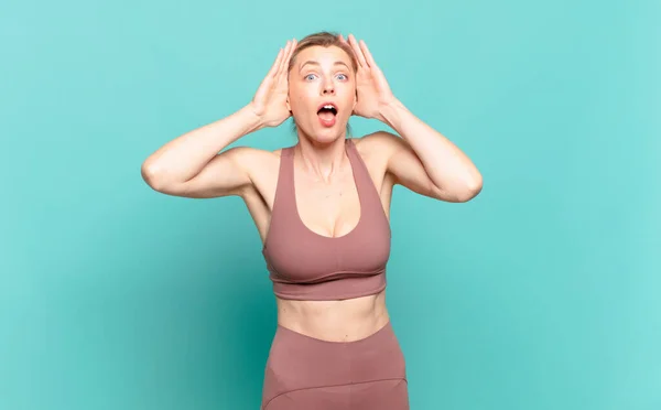 Young Blond Woman Raising Hands Head Open Mouthed Feeling Extremely — 스톡 사진