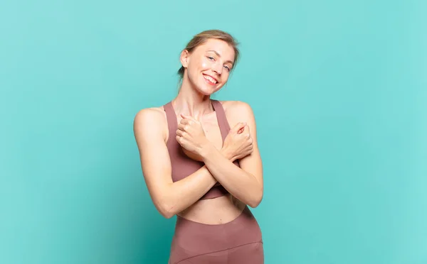 Young Blond Woman Smiling Cheerfully Celebrating Fists Clenched Arms Crossed — 图库照片