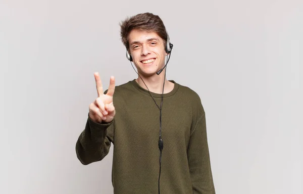 Young Telemarketer Smiling Looking Happy Carefree Positive Gesturing Victory Peace — Stock Photo, Image