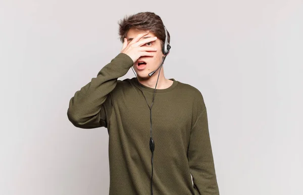 Young Telemarketer Looking Shocked Scared Terrified Covering Face Hand Peeking — Stock Photo, Image