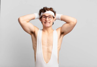 humorous sport man feeling stressed, worried, anxious or scared, with hands on head, panicking at mistake